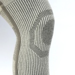 Close-up of a grey, ribbed knit sock showing a geometric pattern on the side.